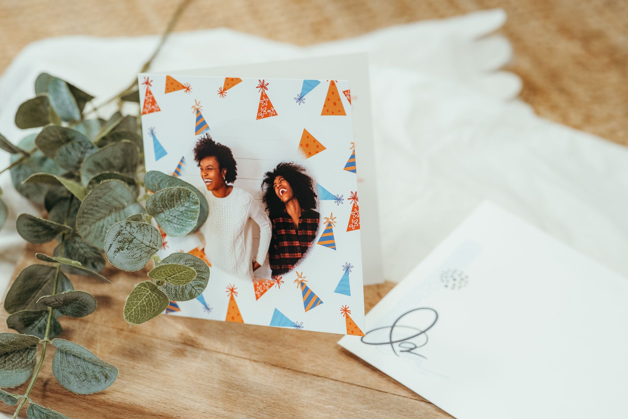 card with hat patterns and two women