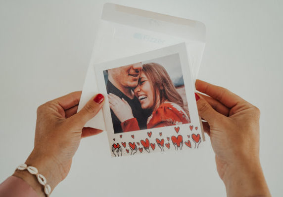 hands holding couple card with heart