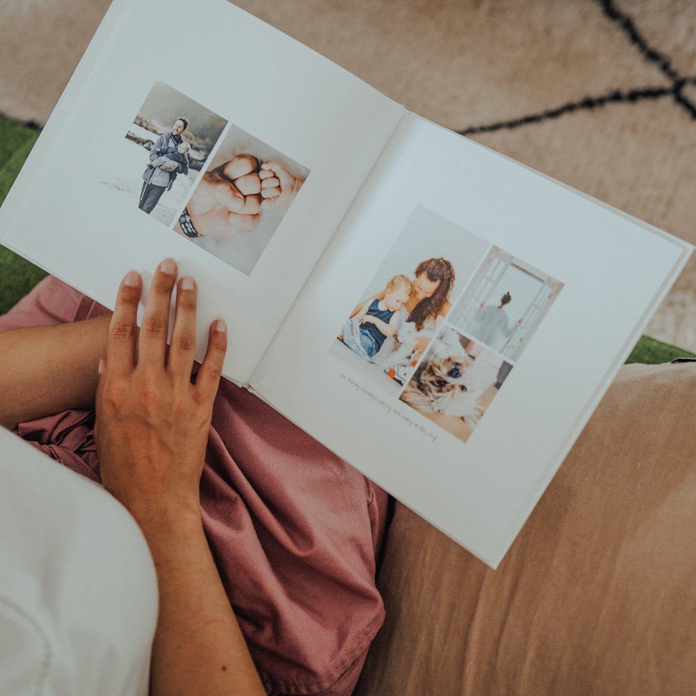 woman reading baby photo album