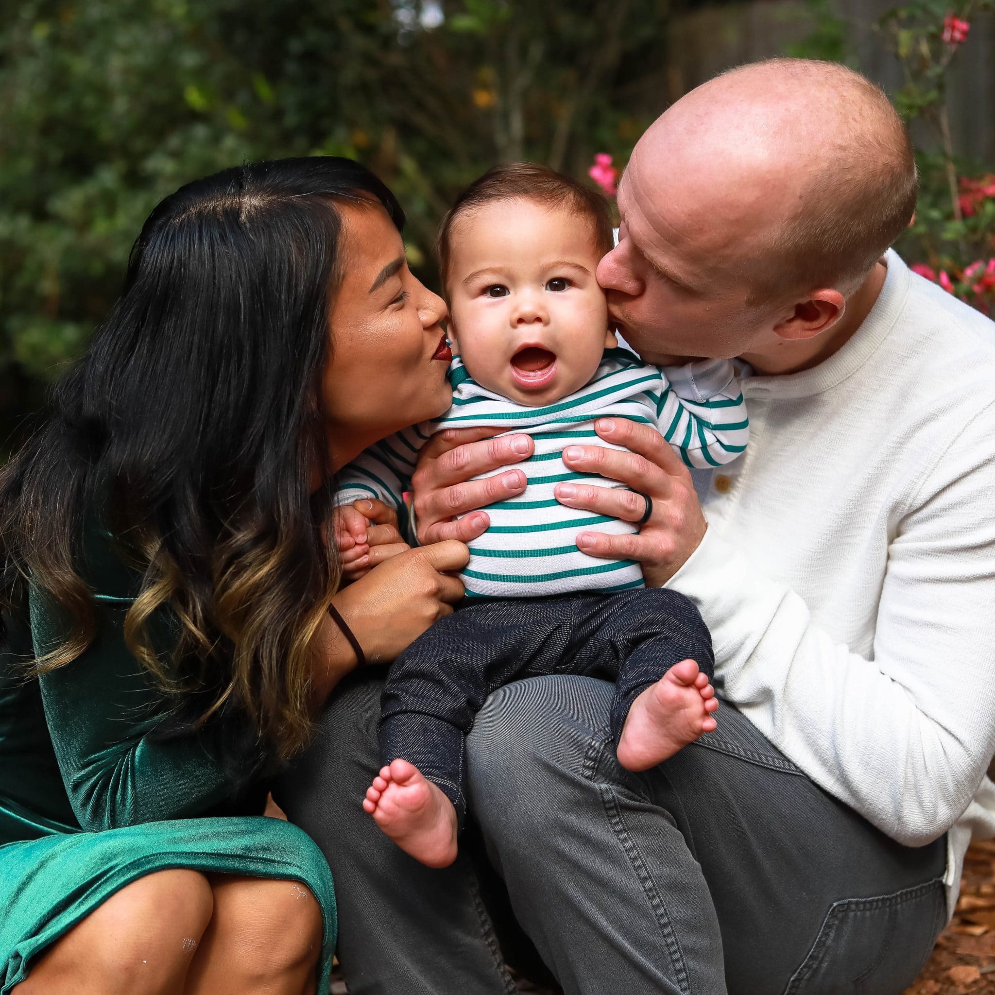 couple kissing a baby