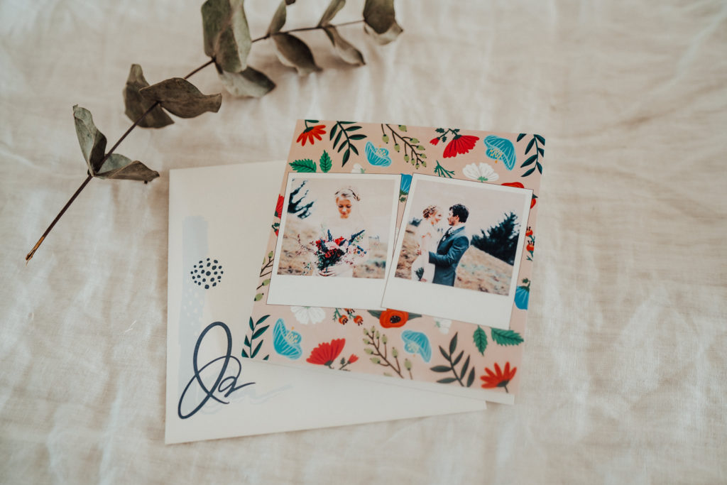 wedding invitation with couple and flowers pose on fabric