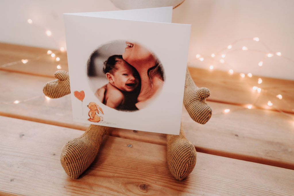 round photo birth card and stuffed rabbit