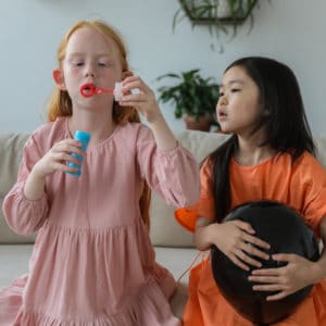 Zwei Mädchen blasen Seifenblasen