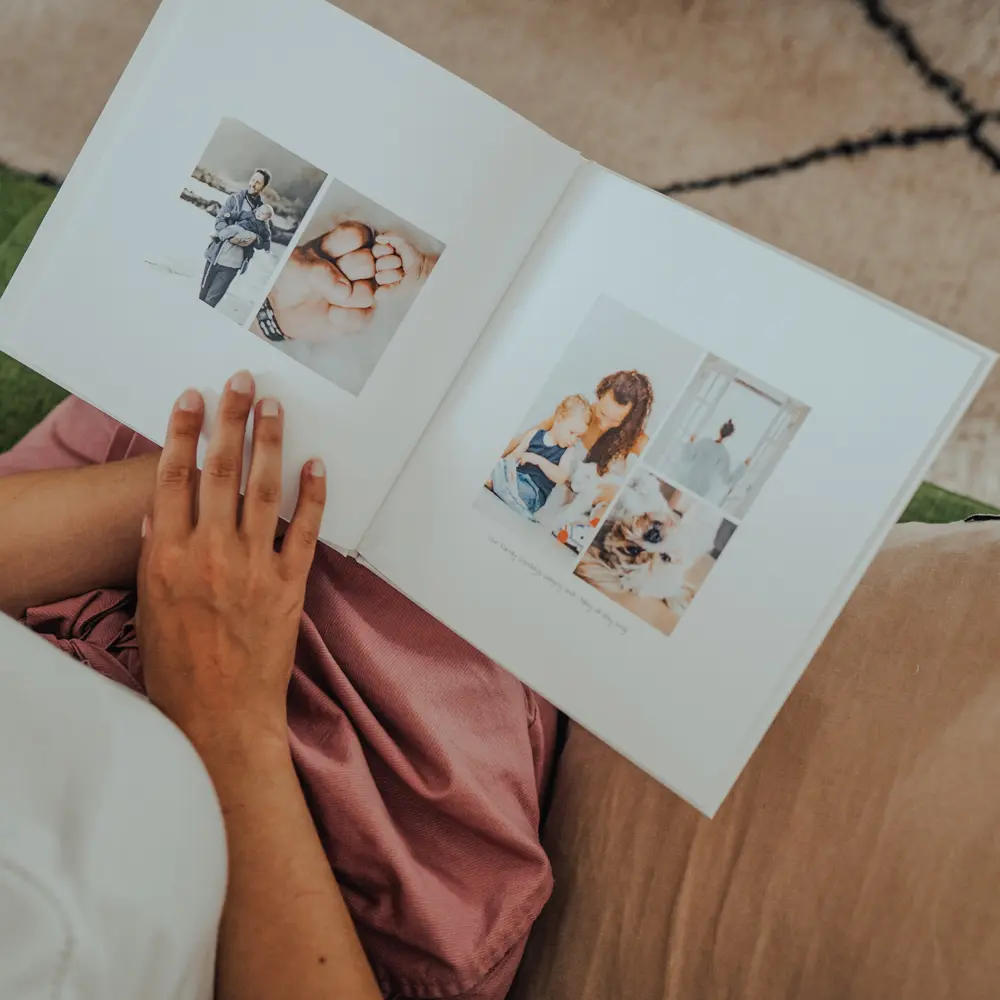 woman reading baby photo book
